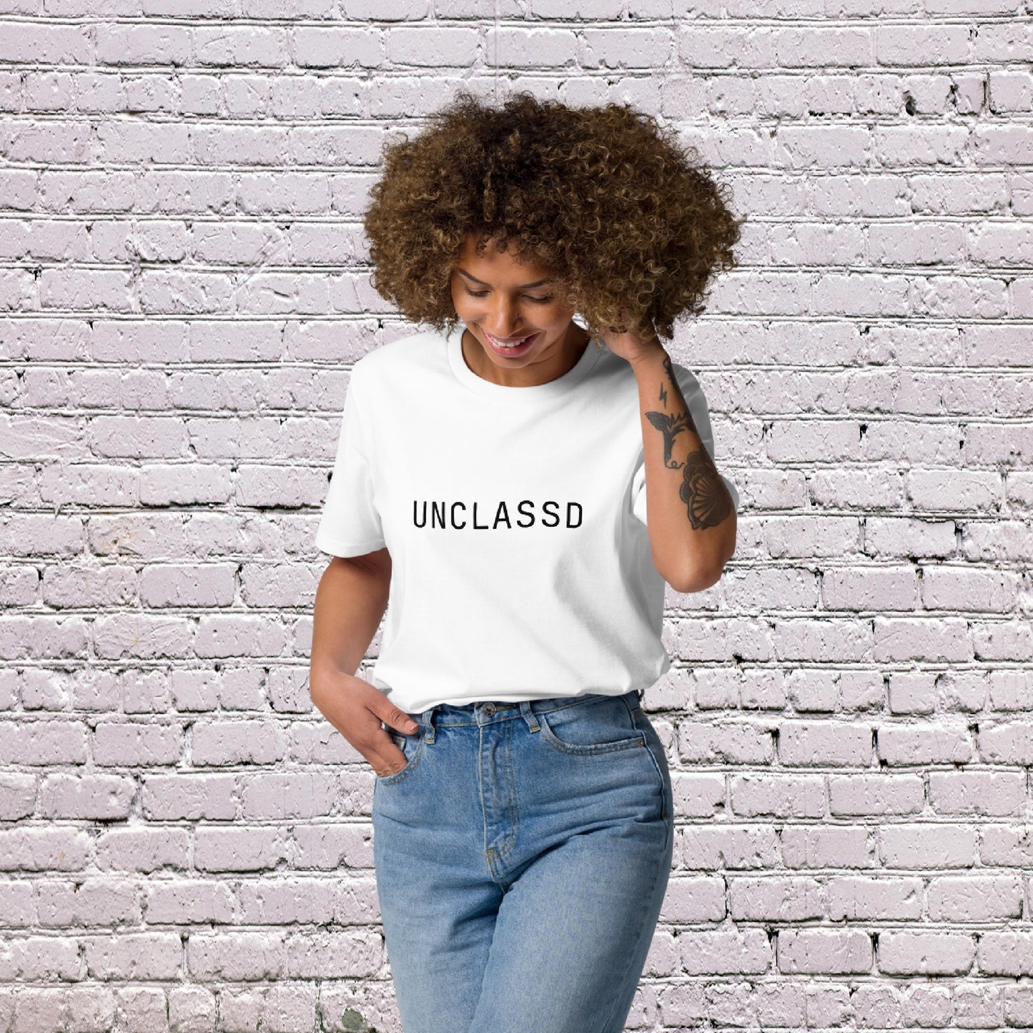 Woman Model wearing UNCLASSD CORE Sand Tee during dance or rollerskate flow practice - face