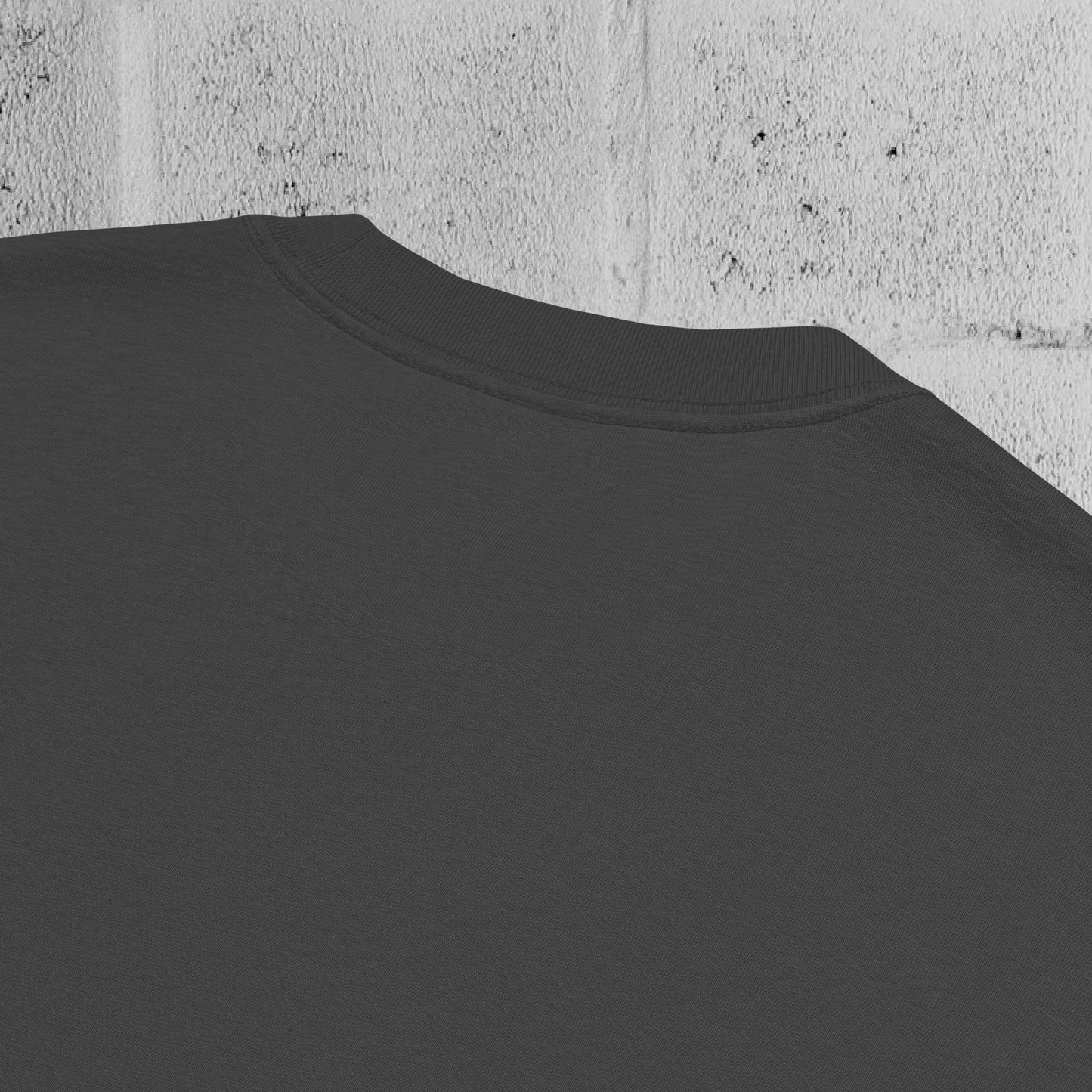 Close-up of heavyweight 240gsm cotton texture from the UNCLASSD CORE Oversized Tee, garment-dyed surface.