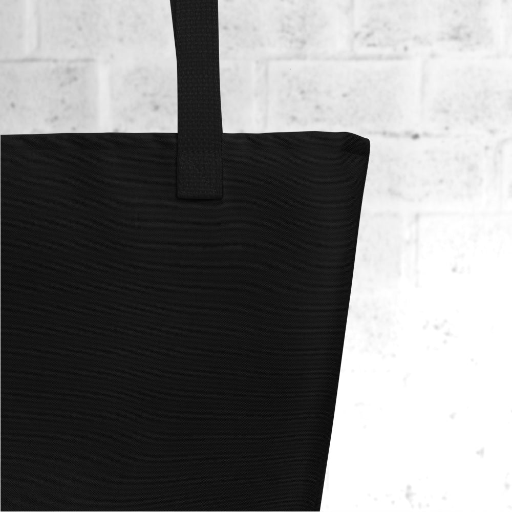 Close-up of black tote bag fabric texture with black handles and structured shape