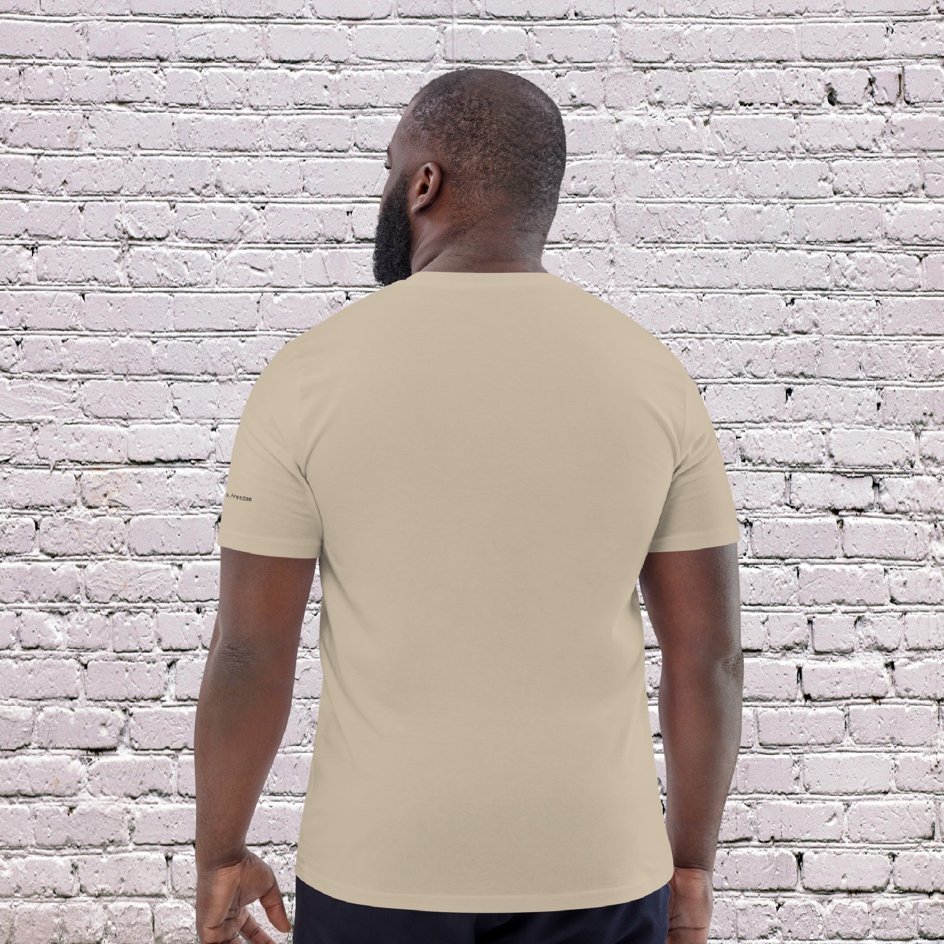 Male Model wearing UNCLASSD CORE Sand Tee during dance or rollerskate flow practice - back 