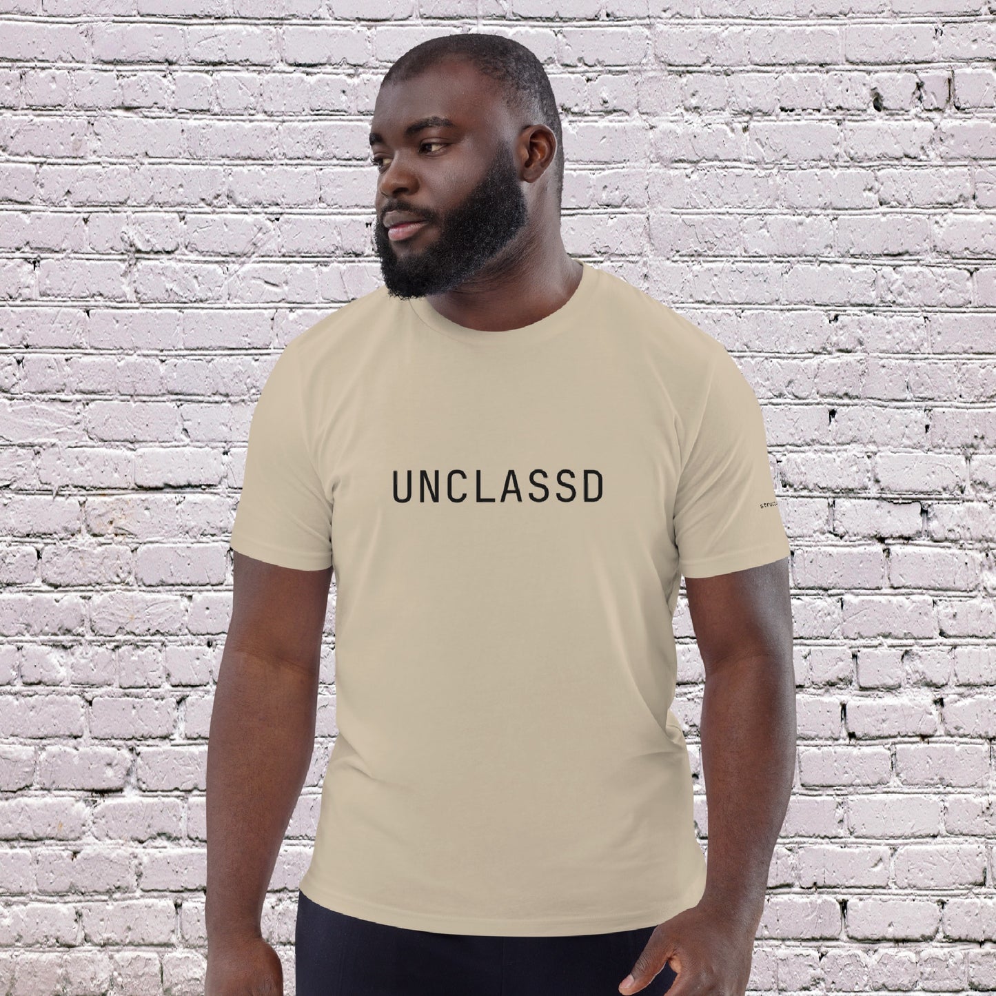 Male Model wearing UNCLASSD CORE Sand Tee during dance or rollerskate flow practice -front 