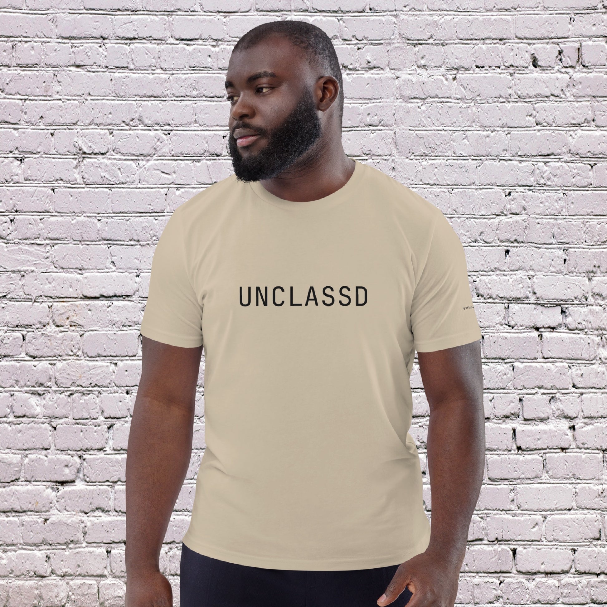 Male Model wearing UNCLASSD CORE Sand Tee during dance or rollerskate flow practice -front 