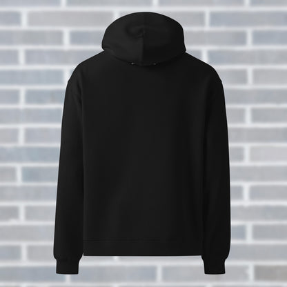 Back view of UNCLASSD black oversized hoodie with subtle Ground Your Fire mantra at neck - for dancers and movers