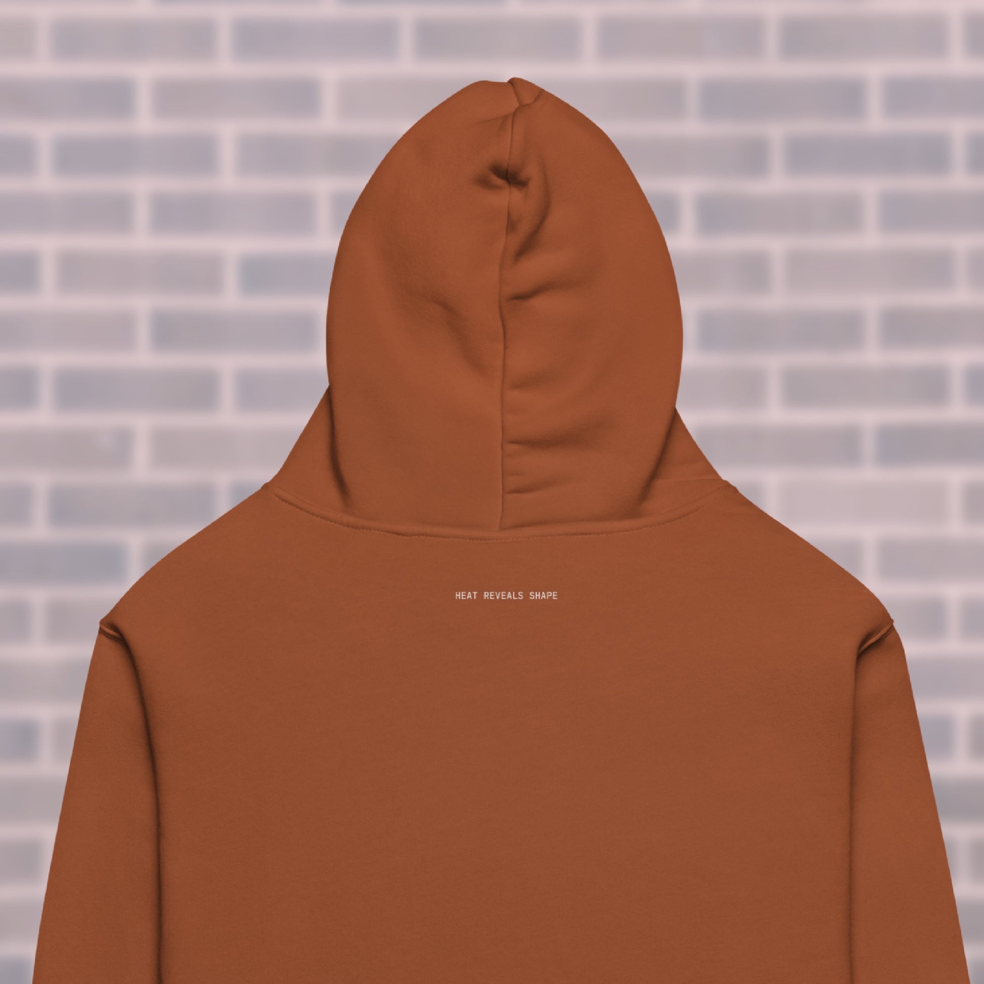 Clay CORE Hoodie back view with mantra “Heat Reveals Shape” — dancers & rollerskaters