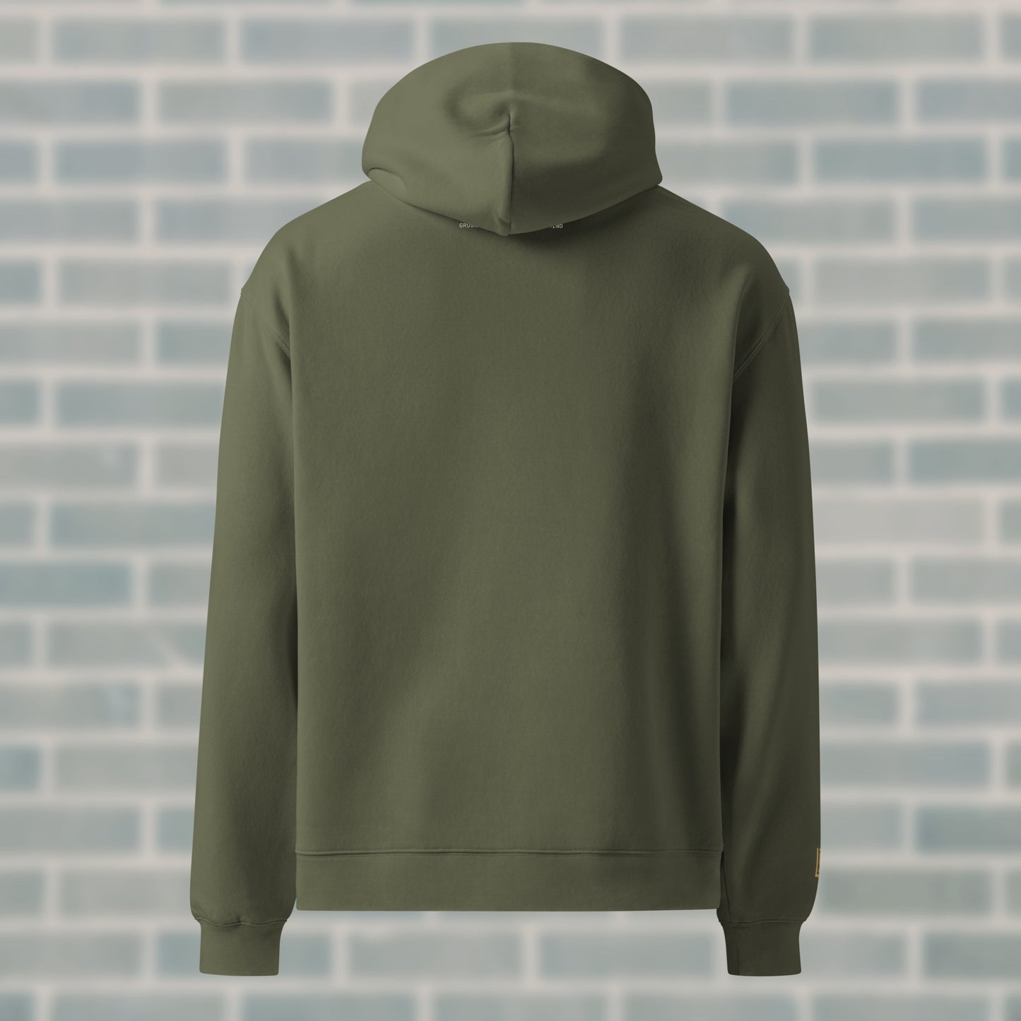 Back view of UNCLASSD Cypress Hoodie — mantra “GROUND MOVEMENT, GROUND MIND” printed high on the spine. Earth-tone streetwear built for dance, groove work, and roller skating.