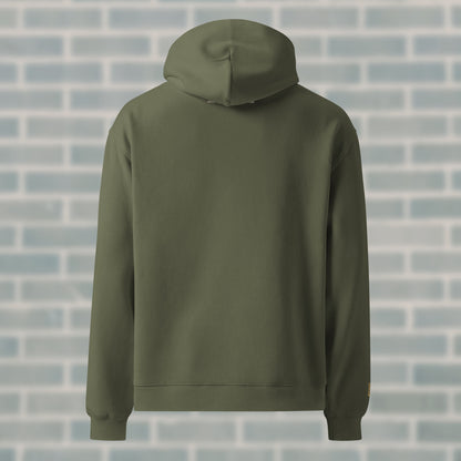 Back view of UNCLASSD Cypress Hoodie — mantra “GROUND MOVEMENT, GROUND MIND” printed high on the spine. Earth-tone streetwear built for dance, groove work, and roller skating.