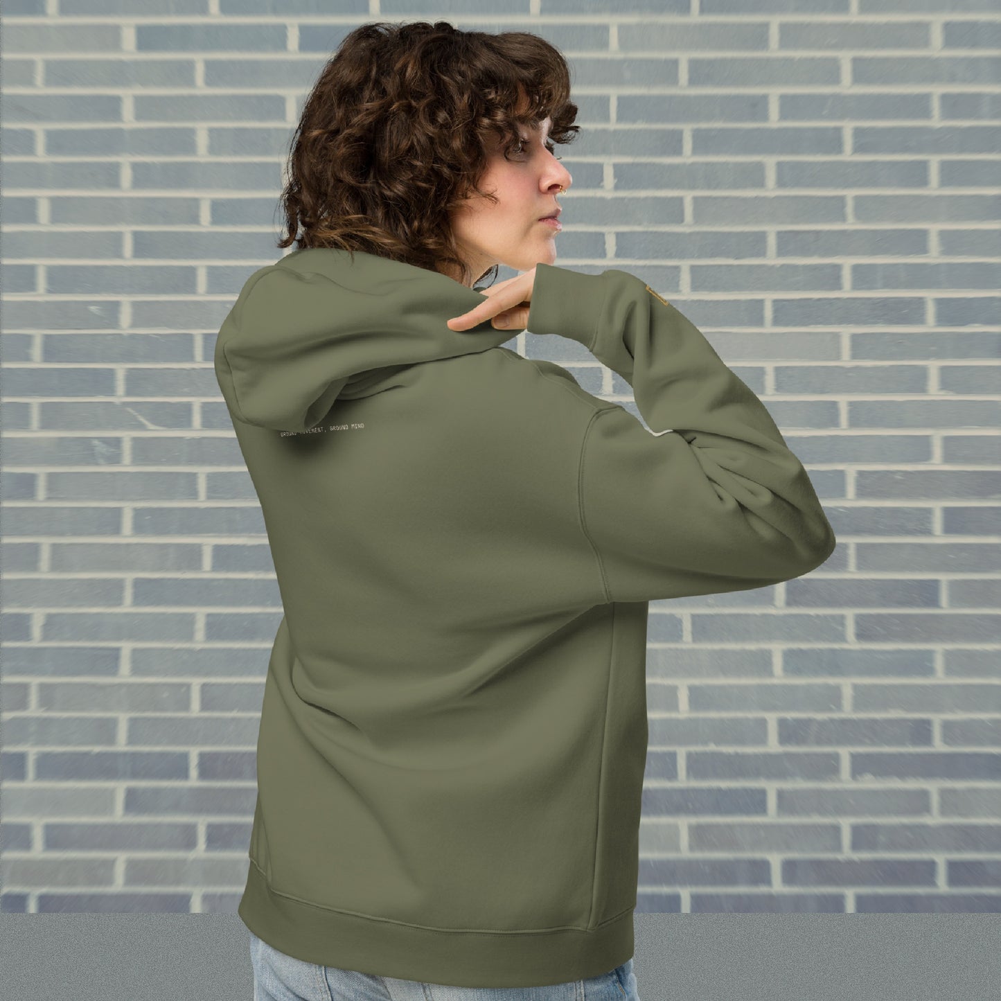 Woman wearing UNCLASSD Cypress oversized hoodie — stable earth-frequency tone for dancers, contemporary movers, and rollerskaters seeking grounded flow. back