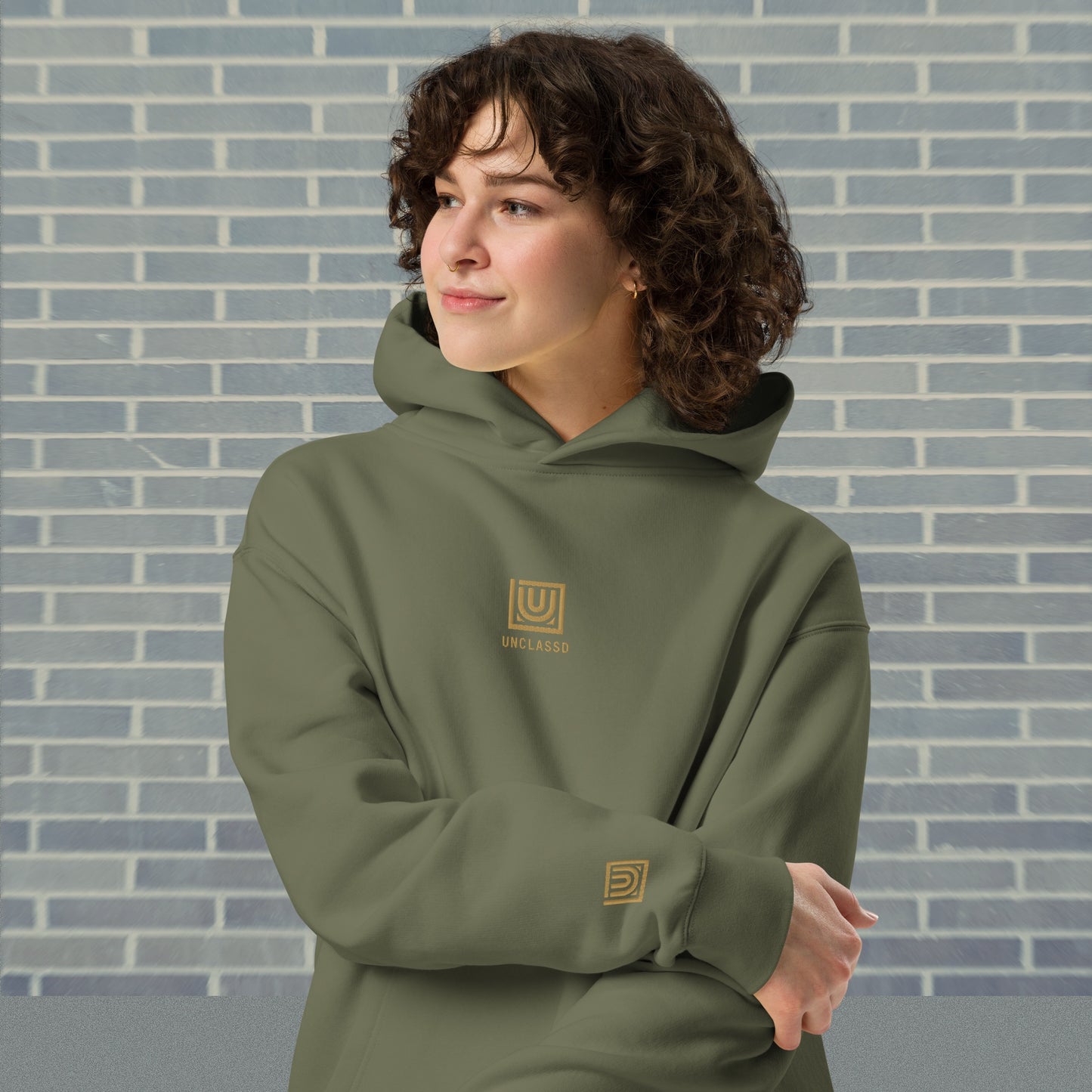 Woman wearing UNCLASSD Cypress oversized hoodie — stable earth-frequency tone for dancers, contemporary movers, and rollerskaters seeking grounded flow.Front