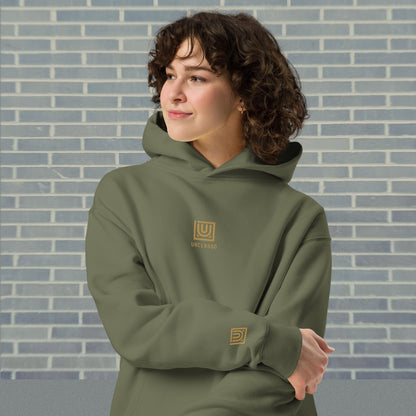 Woman wearing UNCLASSD Cypress oversized hoodie — stable earth-frequency tone for dancers, contemporary movers, and rollerskaters seeking grounded flow.Front