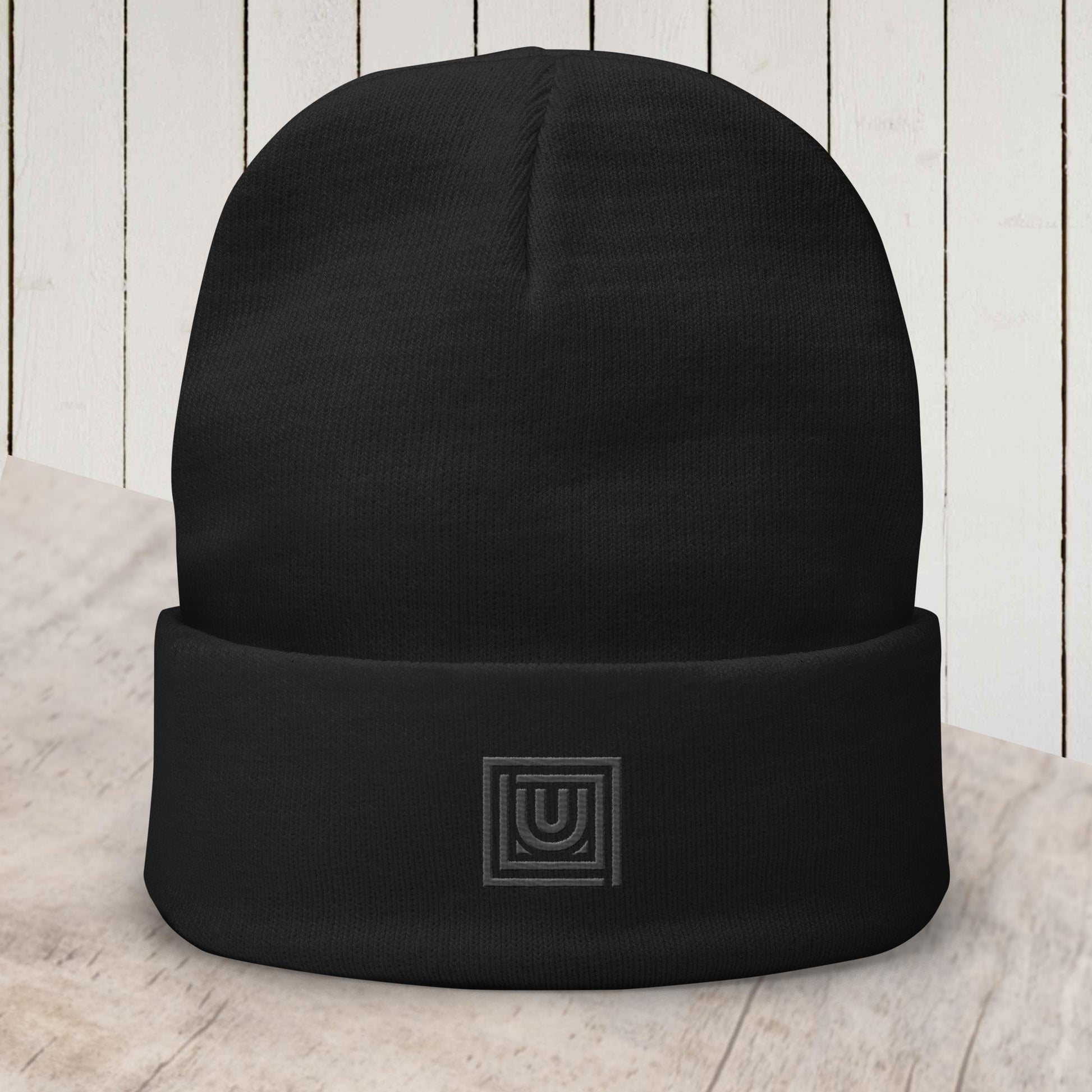 Black beanie with embroidered monogram designed for dance and studio wear