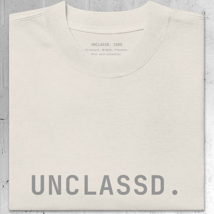Tonal “UNCLASSD.” chest print detail on the CORE Oversized Tee in Bone color.