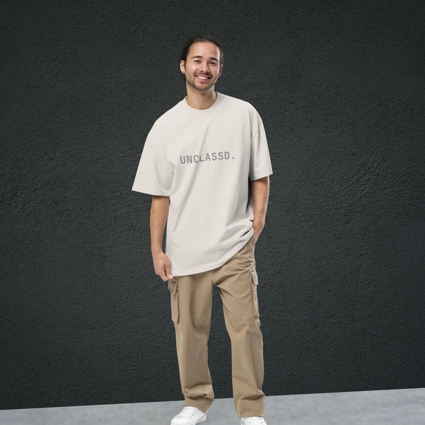 Model wearing the UNCLASSD CORE Oversized Tee in bone color, boxy streetwear fit designed for movement.