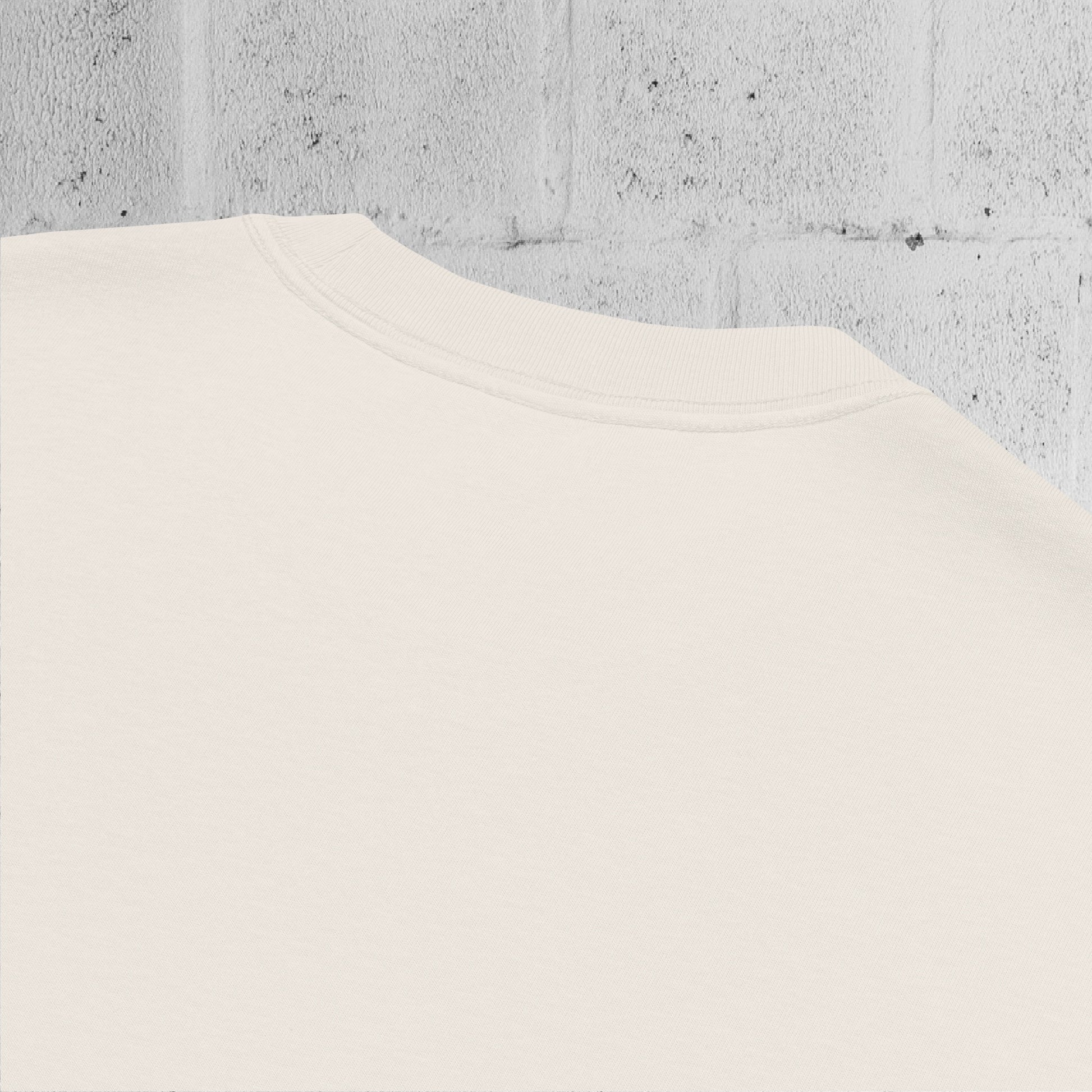 Close-up of wide ribbed neckline on the UNCLASSD CORE Oversized Tee, bone color, showing construction and finish.
